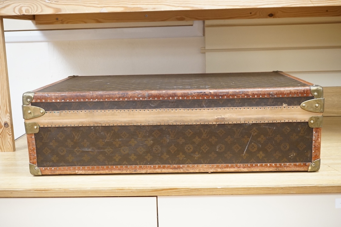 A vintage Louis Vuitton monogram suitcase with two original keys, numbered 793692 to the linen covered interior, height 22cm, width 76cm, depth 46cm